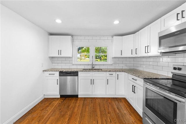 9869 Hazard Rd, Marcy, NY 13403 - kitchen with stainless steel appliances, a sink, light stone counters, decorative backsplash, and white cabinets