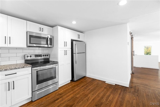 9869 Hazard Rd, Marcy, NY 13403 - kitchen featuring stainless steel appliances, baseboards, decorative backsplash, white cabinetry, and recessed lighting