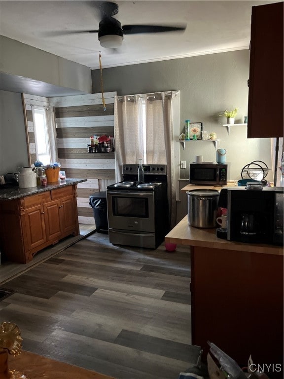 kitchen with dark hardwood / wood-style floors and stainless steel electric range oven