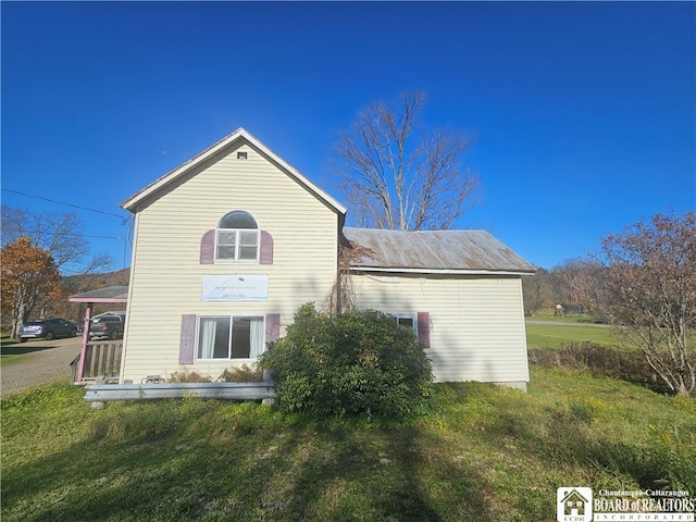 rear view of property with a yard