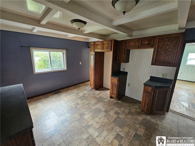 kitchen with beamed ceiling and a healthy amount of sunlight