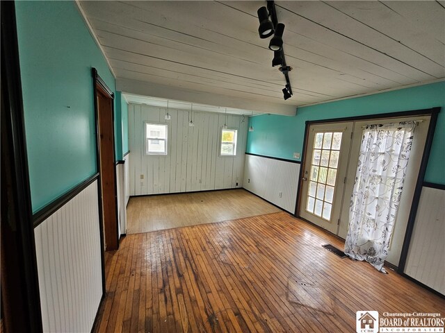 foyer entrance with rail lighting, light hardwood / wood-style floors, and a wealth of natural light