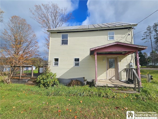 back of house with a yard