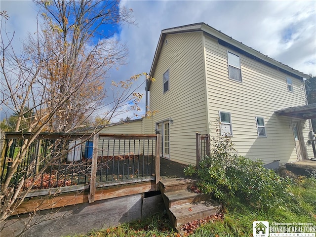 back of property featuring a wooden deck