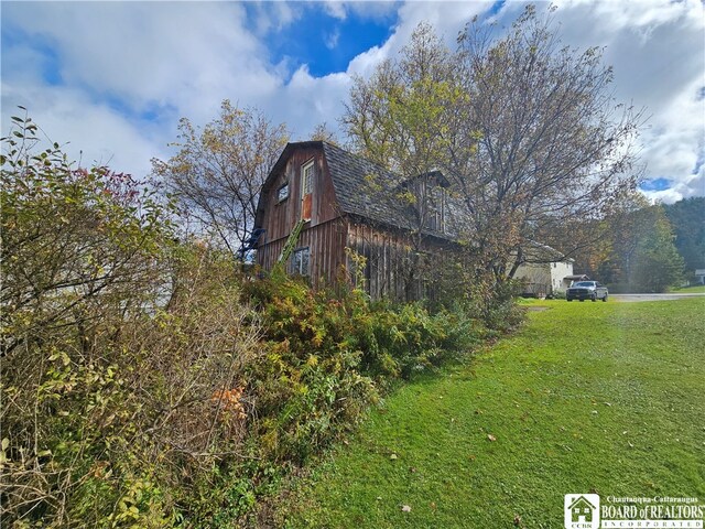 view of side of home with a lawn