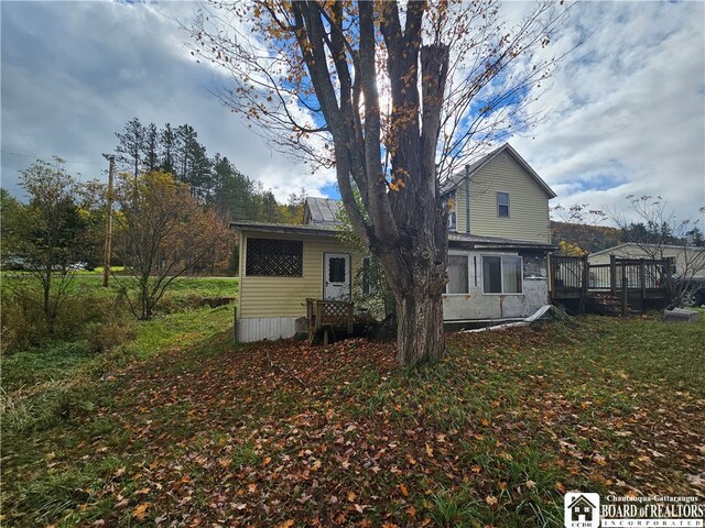 back of house with a gazebo and a yard