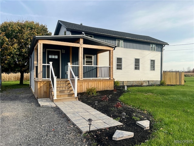 view of front facade with a front yard and a porch