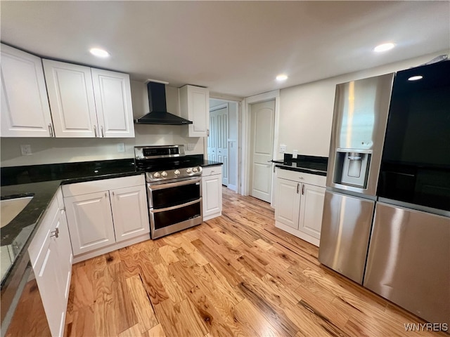 kitchen with white cabinetry, wall chimney range hood, and stainless steel appliances