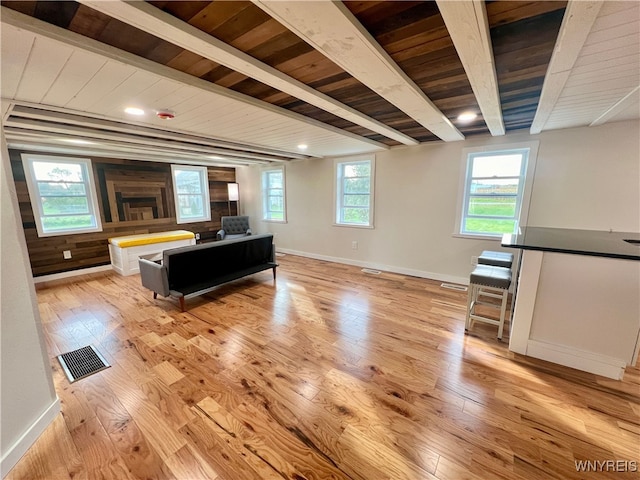 living room with beam ceiling, wooden ceiling, and light wood-type flooring