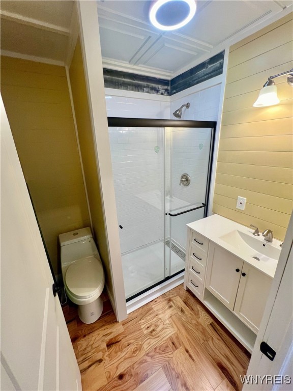 bathroom with vanity, an enclosed shower, hardwood / wood-style flooring, and toilet