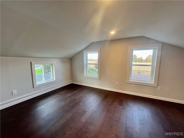 bonus room with lofted ceiling and dark hardwood / wood-style floors