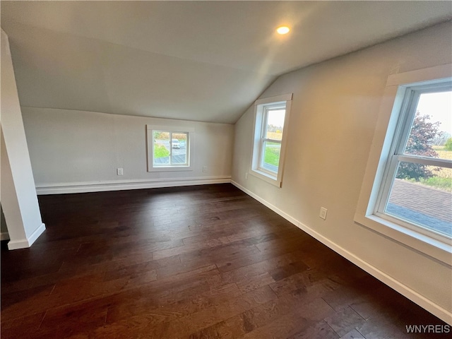 bonus room with a healthy amount of sunlight, vaulted ceiling, and dark hardwood / wood-style floors