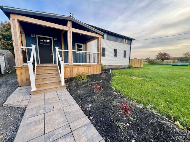 view of front of home with a yard and a porch