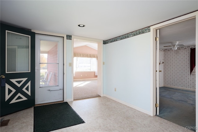 doorway to outside with ceiling fan, light colored carpet, and vaulted ceiling