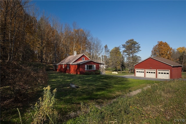 exterior space with a yard, an outbuilding, and a garage