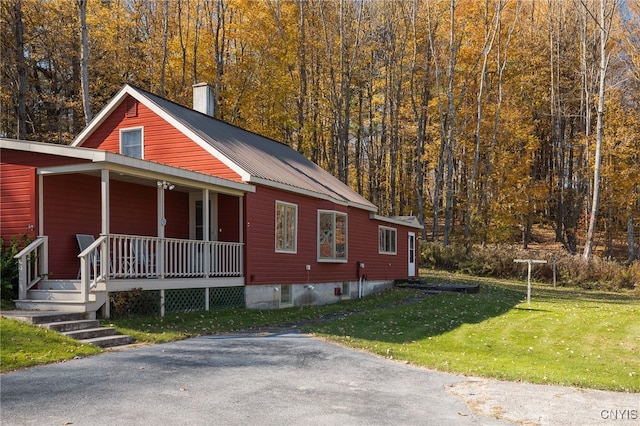 view of front of property with a front yard and a porch