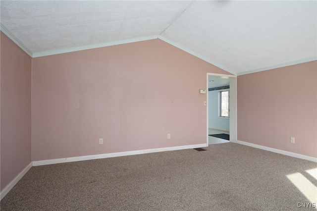 empty room with crown molding, a textured ceiling, vaulted ceiling, and carpet flooring