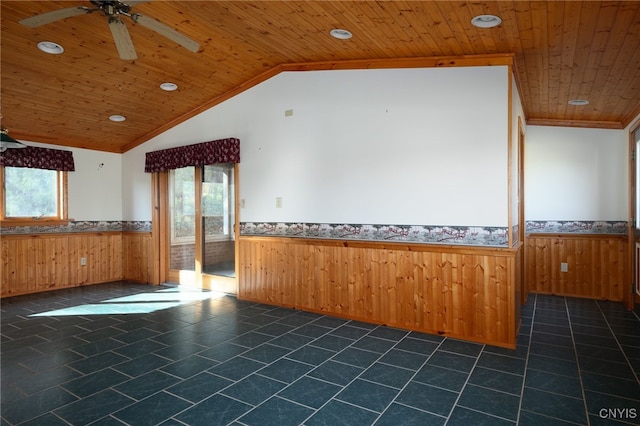 empty room featuring wood ceiling, plenty of natural light, and vaulted ceiling