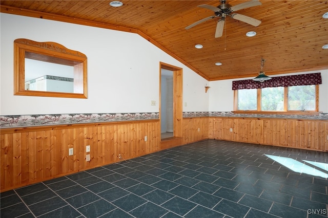 unfurnished room featuring lofted ceiling, ceiling fan, wooden ceiling, ornamental molding, and wood walls