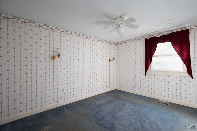 empty room with carpet floors, a textured ceiling, and ceiling fan