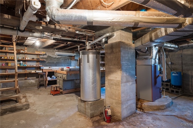 basement featuring water heater and heating unit