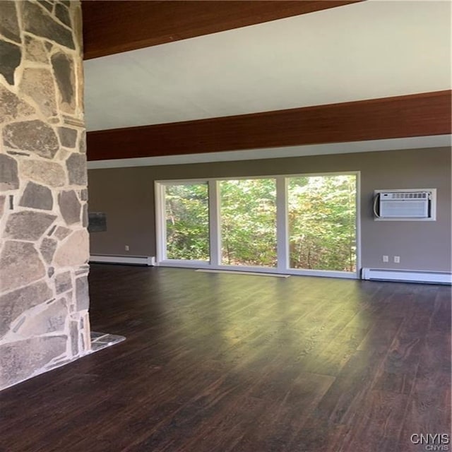 unfurnished living room featuring baseboard heating, dark wood-type flooring, beam ceiling, and a wall mounted air conditioner