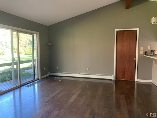 spare room with dark wood-type flooring and a baseboard heating unit