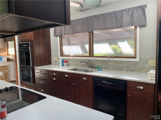 kitchen with black appliances, sink, backsplash, and a wealth of natural light