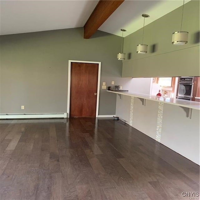 interior space with a kitchen breakfast bar, stainless steel oven, pendant lighting, and dark hardwood / wood-style floors