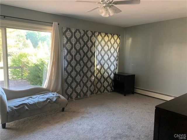 sitting room with ceiling fan, a baseboard heating unit, and carpet floors