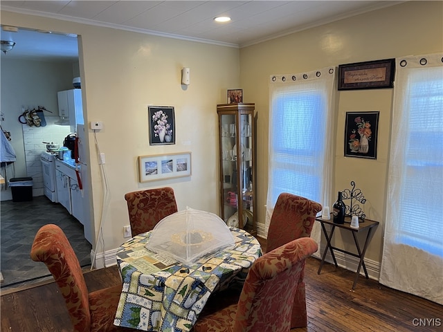 dining area with crown molding and dark hardwood / wood-style flooring