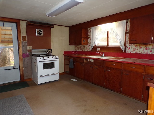 kitchen with white range, sink, and light colored carpet