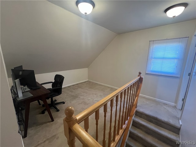 home office featuring lofted ceiling and carpet