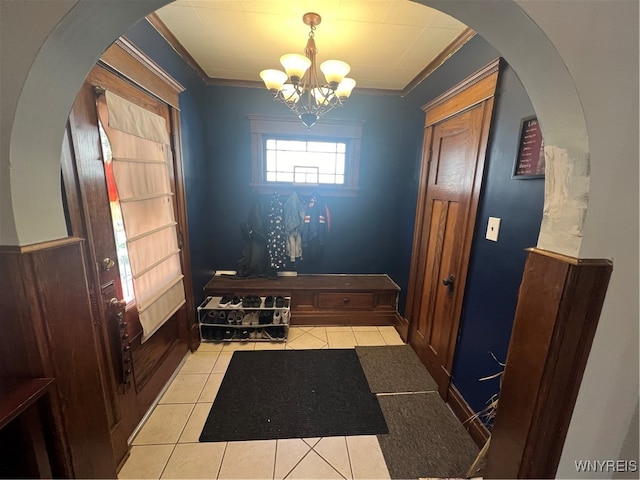 interior space with crown molding, light tile patterned flooring, and a chandelier