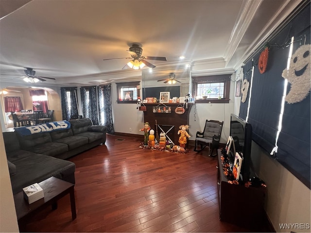 living room with ornamental molding, a brick fireplace, and dark hardwood / wood-style flooring