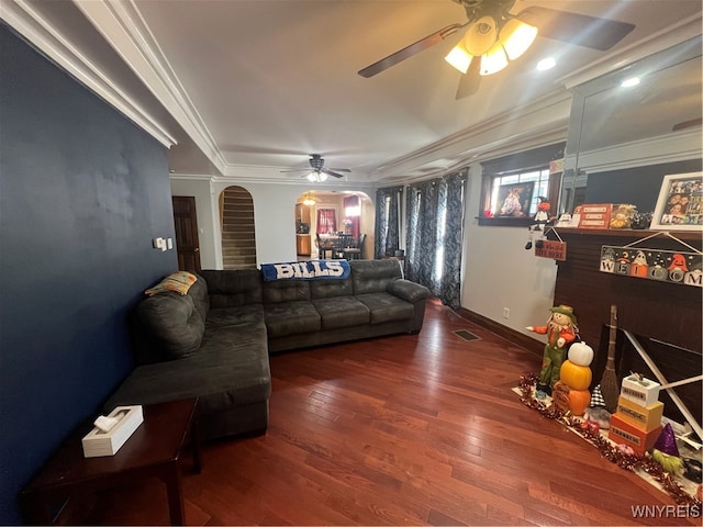 living room featuring ornamental molding, wood-type flooring, and ceiling fan