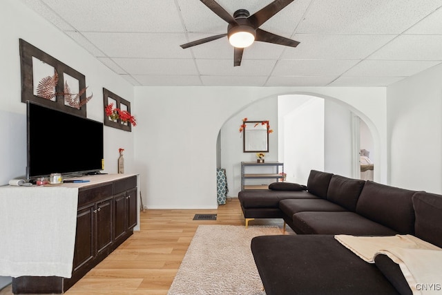 living room featuring light hardwood / wood-style floors, a paneled ceiling, and ceiling fan