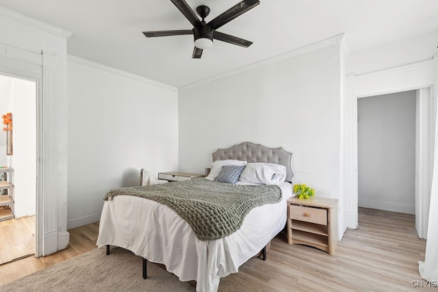 bedroom featuring ceiling fan, crown molding, and light hardwood / wood-style flooring