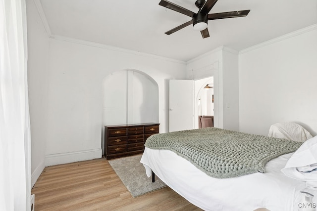 bedroom with ornamental molding, hardwood / wood-style flooring, and ceiling fan