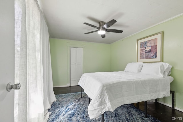 bedroom with a closet, ceiling fan, and dark hardwood / wood-style floors