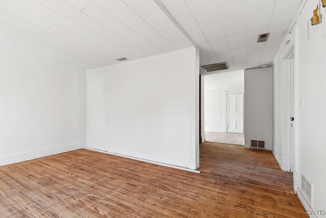 empty room with hardwood / wood-style flooring