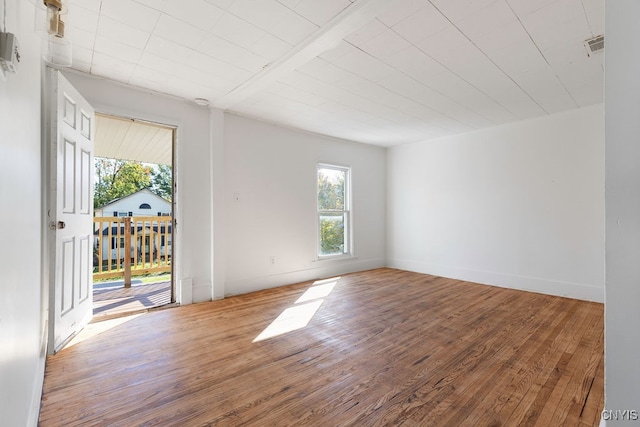 spare room with hardwood / wood-style flooring