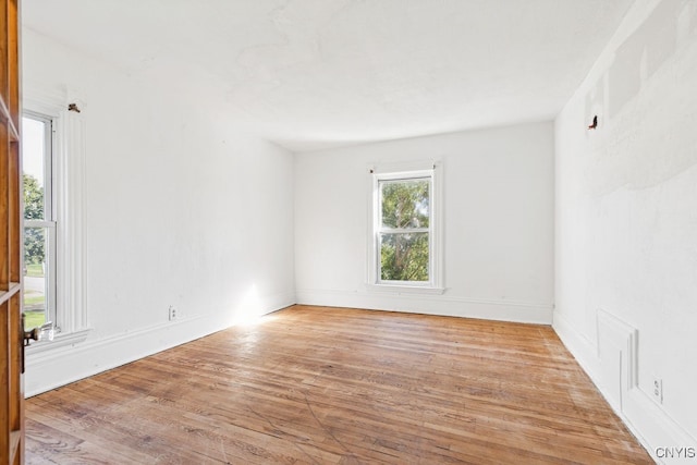 unfurnished room with light wood-type flooring