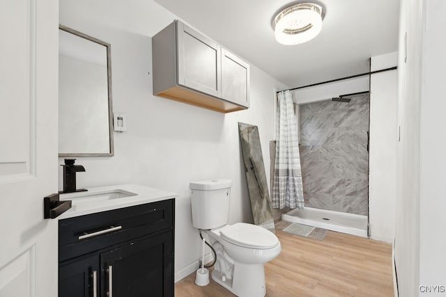 bathroom with vanity, toilet, hardwood / wood-style flooring, and a shower with shower curtain