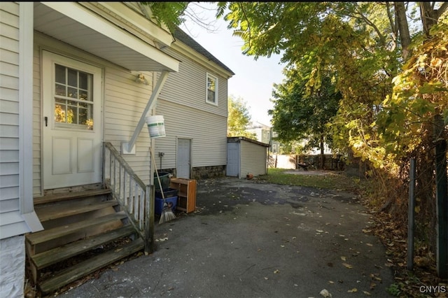 view of property exterior featuring a storage shed