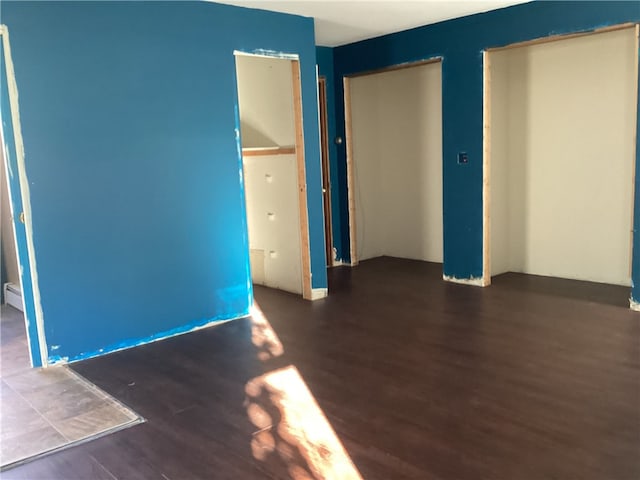 unfurnished room featuring dark hardwood / wood-style floors