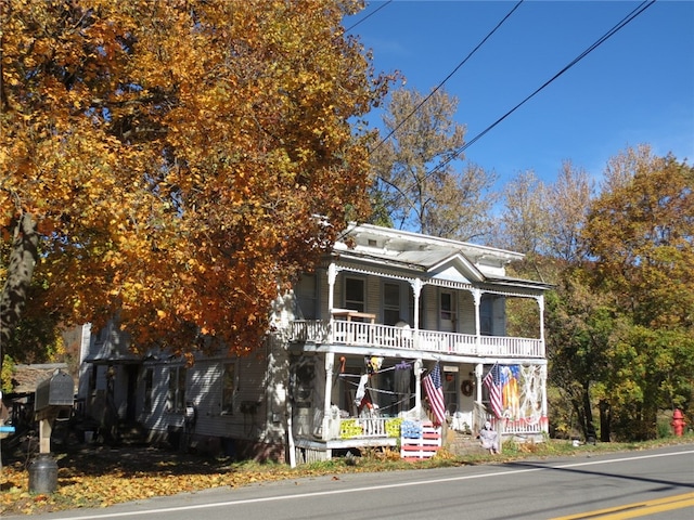 view of front of property with a balcony and a porch