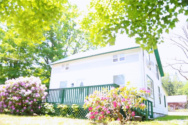 back of house with a deck