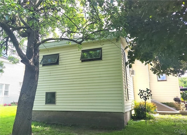 view of side of property with a yard