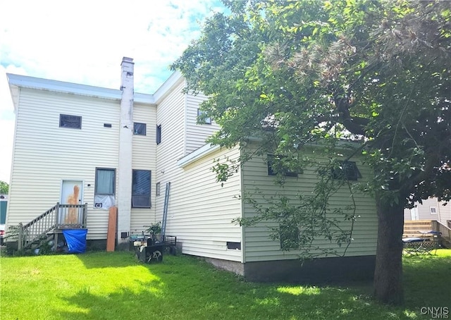 rear view of property featuring a yard